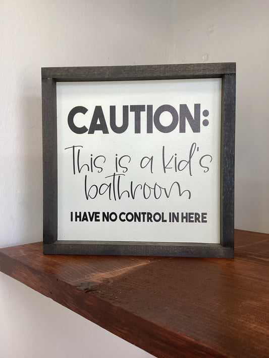 Caution this is a kid bathroom sign